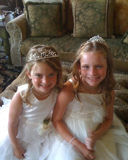 Chasey Calaway and Gracie Calaway in white gowns and princes crowns.
